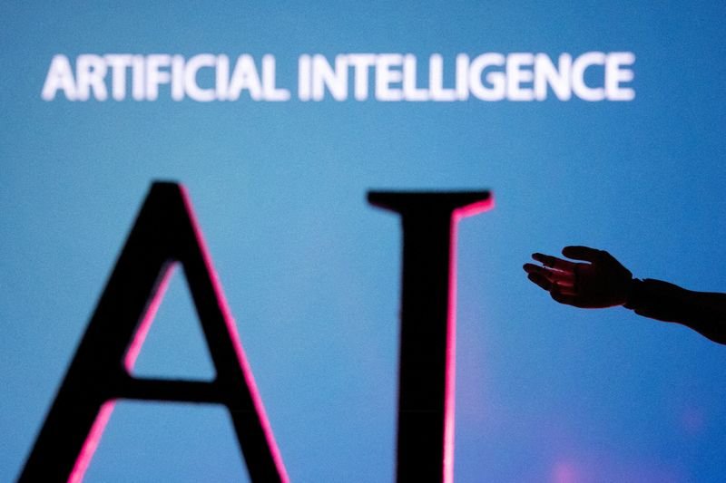 file photo: illustration shows ai (artificial intelligence) letters and robot hand miniature